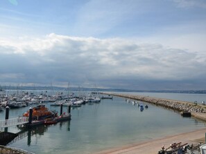A marina with boats docked, a pier, and a stone breakwater. - 2 Bed in Brixham (oc-88998) (Brixham)