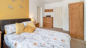 A bedroom with a bed, nightstands, a dresser, a wardrobe, and a ceiling light fixture. - 1 Bed in Fordingbridge (oc-49266) (Frogham)