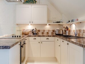 A modern kitchen with white cabinets, a granite countertop, a kettle, a toaster, and a sink with a faucet. - 2 Bed in Bridgwater (oc-chanp) (Bridgwater)
