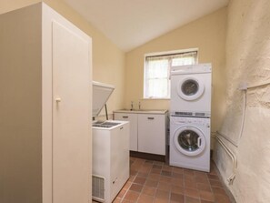 A laundry room with a washing machine, dryer, and a small sink. - 4 Bed in Kendal (oc-sz100) (Longsleddale)