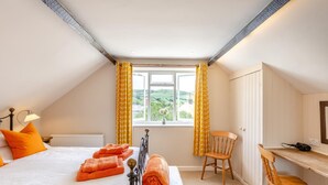 A bedroom with a bed, a desk, a chair, and a window with curtains. - 2 Bed in Bridport (oc-dc110) (Chideock)