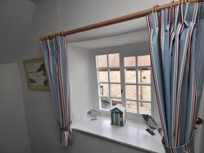 A room with a window, a wooden beam, and striped curtains. - 2 Bed in Wareham (oc-dc093) (West Lulworth)