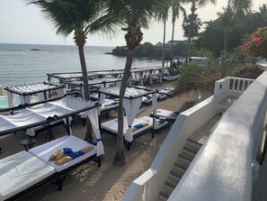 A beachside hotel with rows of sunbeds, a pool, and a view of the sea. - Royal Villa 4-bedroom Villa-January 15, 2027-January 22, 2027 (Cofresi)