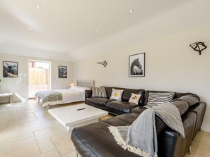 A modern bedroom with a bed, a sofa, and a coffee table. - 1 Bed in Manningtree (oc-78388) (Lawford)