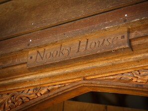 A wooden sign with the inscription 'Nooky House' on a wooden structure. - 2 Bed in Holt (oc-ncc39) (Cley next the Sea)