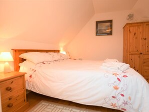A bedroom with a bed, a nightstand, a wooden wardrobe, and a wall-mounted picture. - 1 Bed in King's Lynn (oc-73108) (West Rudham)