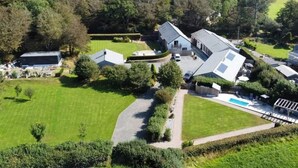 A large house with a swimming pool, surrounded by green lawns and trees. - 2 Bed in Holsworthy (oc-50598) (Sessacott)