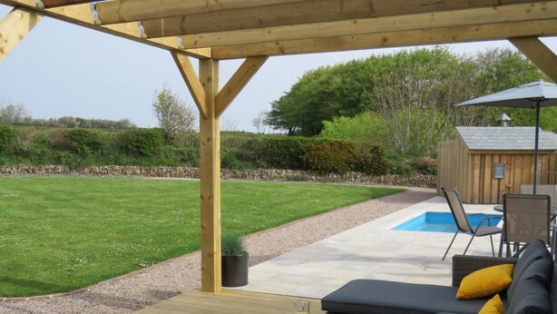 A covered patio with a pool, outdoor furniture, and a wooden deck. - 2 Bed in Holsworthy (oc-50598) (Sessacott)