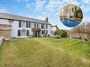A two-story house with a well-maintained lawn and a small garden. - 4 Bed in Bude (oc-41608) (Poundstock)