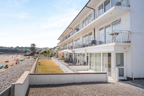 A multi-story hotel with balconies, a pool area, and a beach view. - 1 Bed in Saundersfoot (oc-fb243) (Saundersfoot)