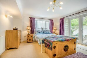 A bedroom with a bed, bedside tables, a wardrobe, and a window with curtains. - 1 Bed in Ringwood (oc-50147) (Ashley Heath)