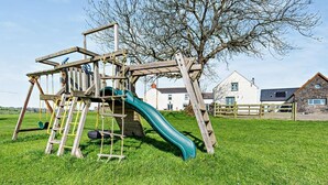 A playground with a slide and climbing structures. - 2 Bed in Narberth (oc-72864) (Whitland)
