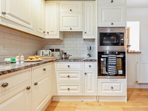 A kitchen with white cabinetry, a stainless steel oven, and a microwave. - 2 Bed in Narberth (oc-72865) (Whitland)