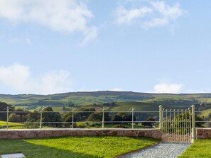 A rural landscape with rolling hills, a stone pathway, and a metal gate. - 3 Bed in Ratlinghope (oc-79238) (Ratlinghope)