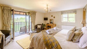 A bedroom with a bed, a desk, a chair, a TV, and a balcony. - 6 Bed in Bala (oc-80348) (Fron-goch)