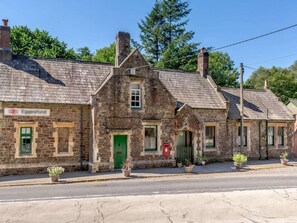 A stone building with a green door, windows, and a sign that reads 'Eggesford.' - 1 Bed in Chulmleigh (oc-88862) (Chawleigh)