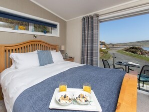 A hotel room with a bed, breakfast tray, and a view of the outdoors. - 1 Bed in Castle Douglas (oc-rasc1) (Auchencairn)