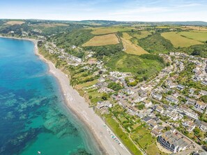 A coastal town with a beach, residential areas, and rolling hills in the background. - 2 Bed in Torpoint (oc-88478) (Downderry)