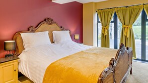 A bedroom with a large bed, a nightstand, a lamp, and a window with curtains. - 2 Bed in Stoke-on-trent (oc-94790) (Waterhouses)