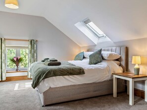 A bedroom with a skylight, a bed with pillows, a bedside table with a lamp, and a window with curtains. - 2 Bed in Stoke-on-trent (oc-95164) (Longsdon)