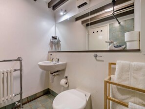A bathroom with a toilet, sink, towel rack, and a mirror. - 6 Bed in Penrith (oc-95344) (Ullswater)