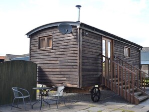 A wooden cabin with a satellite dish, a small porch, and a wheelchair-accessible ramp. - 1 Bed in Kendal (oc-95349) (Ings)