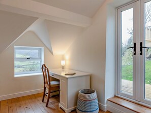A room with a desk, chair, lamp, and a view through a window. - 2 Bed in Corwen (oc-95542) (Corwen)