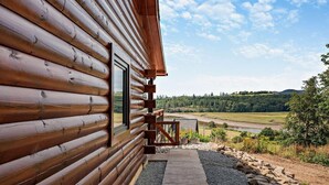 A log cabin with a view of a river and hills. - 4 Bed in Kippford (oc-95234) (Kippford)