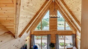 A wooden interior with a sloped ceiling, large windows, and a hanging light fixture. - 4 Bed in Kippford (oc-95234) (Kippford)