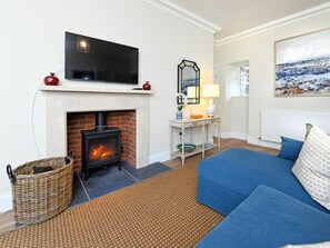 A living room with a fireplace, a sofa, a television, and a painting on the wall. - 3 Bed in Lockerbie (oc-95861) (Hoddom)