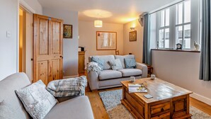 A cozy living room with a sofa, a coffee table, and a window with curtains. - 2 Bed in Ambleside (oc-95914) (Hawkshead)