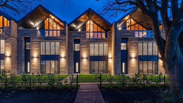 A modern building with a stone facade, large windows, and a central entrance. - 4 Bed in Morpeth (oc-95889) (Amble)