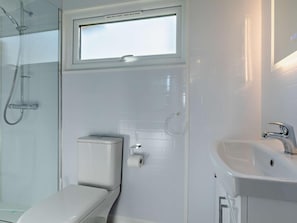 A modern bathroom with a toilet, a shower, and a sink. - 1 Bed in Bridport (oc-90055) (Whitchurch Canonicorum)