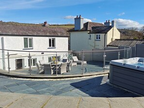 A rooftop terrace with a hot tub, outdoor seating, and a view of surrounding buildings. - 3 Bed in Aberaeron (oc-95971) (Aberaeron)