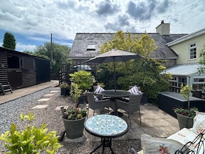 A patio area with outdoor furniture, a table, and potted plants. - 2 Bed in Brecon (oc-bn178) (Llanfihangel Nant Bran)