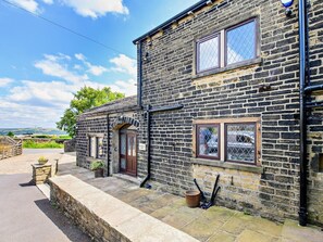 A stone building with a door, windows, and a small garden area. - 5 Bed in Halifax (oc-96061) (Sowerby Bridge)