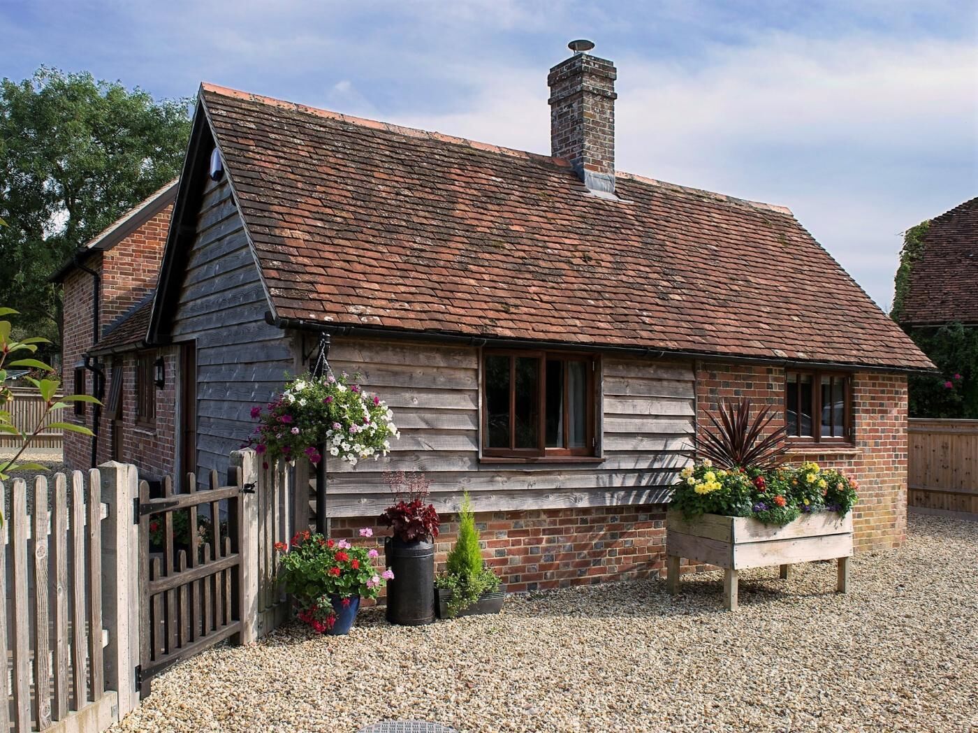 A traditional wooden house with a sloped roof and a chimney.