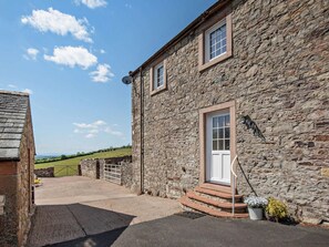 A stone building with a door and steps leading to a driveway. - 2 Bed in Wigton (oc-96088) (Ireby)
