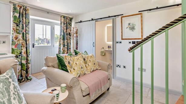 A living room with a sofa, a coffee table, and a staircase. - 1 Bed in Gateshead (oc-95877) (Lamesley)