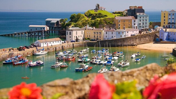 A coastal town with a marina, historic buildings, and a prominent hilltop structure. - 2 Bed in Tenby (oc-96239) (Tenby)