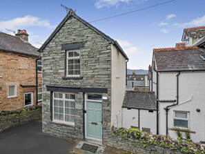 A stone house with a gabled roof, a single window, and a door. - 1 Bed in Keswick (oc-96314) (Keswick)