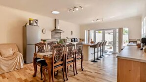 A spacious kitchen with a dining area, wooden flooring, and a large window. - 6 Bed in Pickering (oc-96415) (Newton-on-Rawcliffe)
