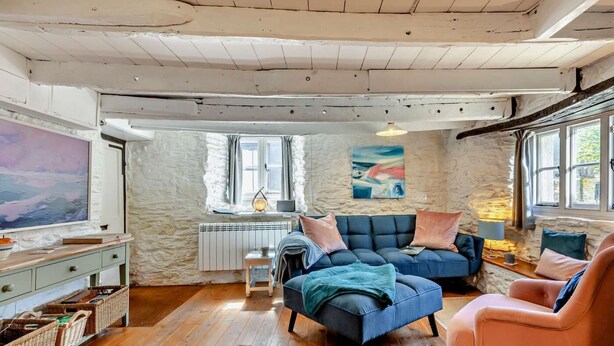 A cozy living room with a sofa, armchair, and a television. - 2 Bed in Kingsbridge (oc-94125) (Malborough)