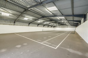 An indoor tennis court with a metal roof and white walls. - 2 Bed in Bude (oc-04727) (Poundstock)