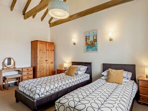 A bedroom with two beds, a wooden wardrobe, a desk, and a chair. - 2 Bed in Bude (oc-04727) (Poundstock)