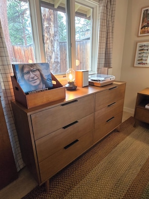 A wooden dresser with drawers, a lamp, and a framed picture on top. - "Camp Cabin"  2-bedroom cabin in serene Estes Park (Estes Park)