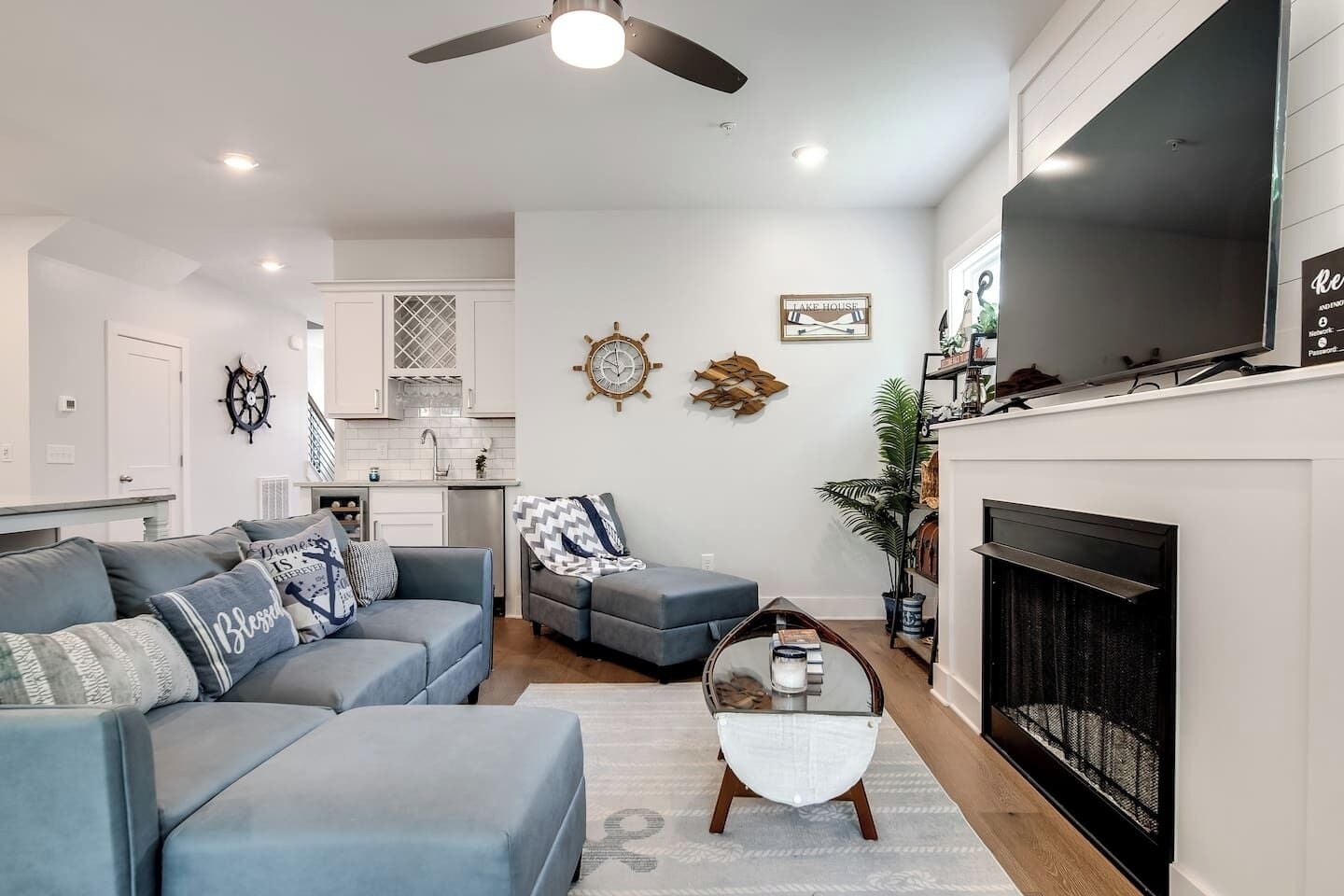 A modern living room with a grey sofa, a coffee table, and a fireplace.