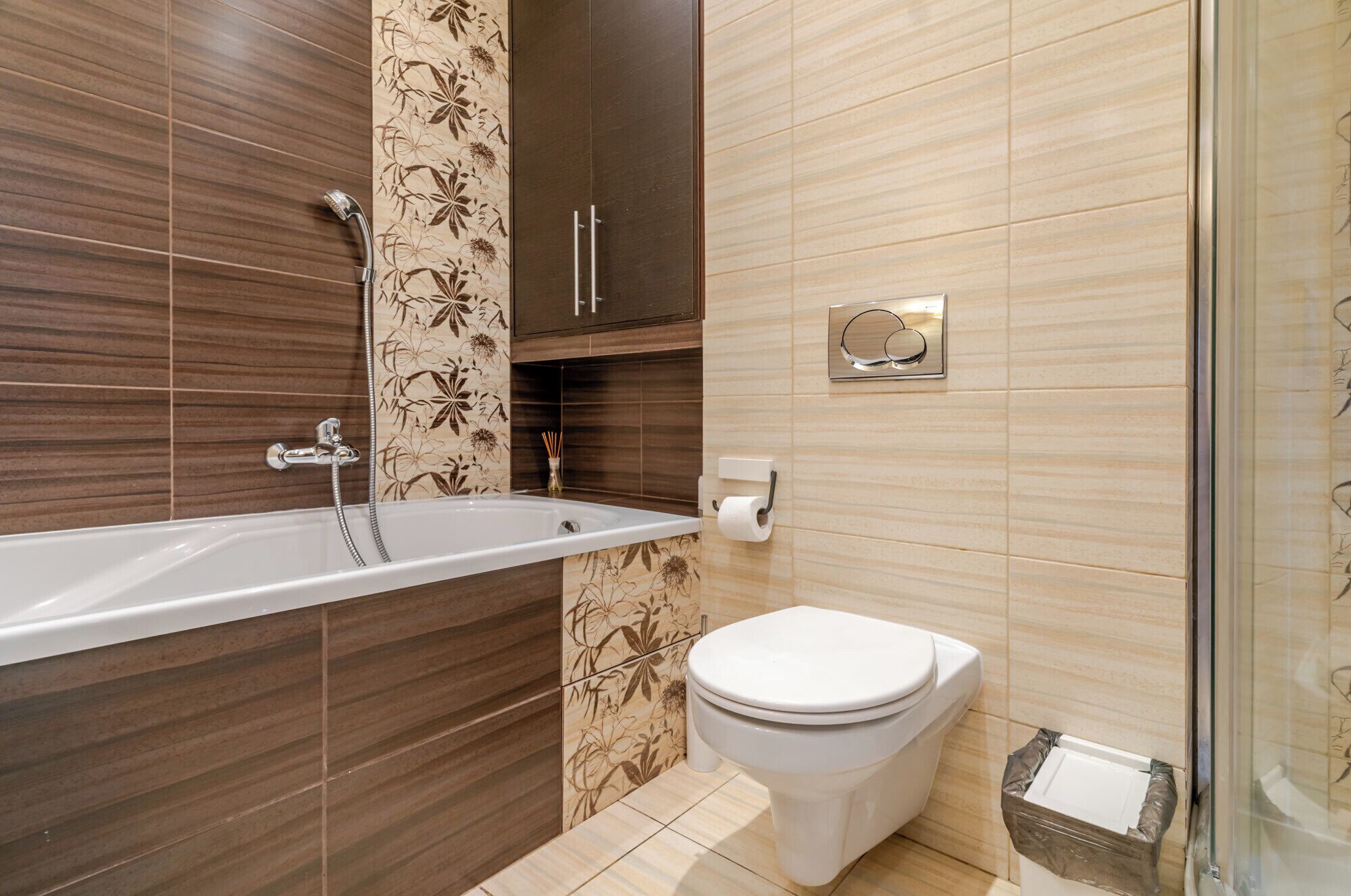 A bathroom with a bathtub, toilet, and shower.