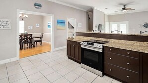 A kitchen with a stove, oven, and granite countertop. - Sugar Sand 30A Retreat - 5BR Seagrove Home w/ Private Pool, 3 min walk to Beach! (Santa Rosa Beach)