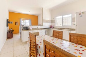 A compact kitchen with a microwave, toaster, and sink.